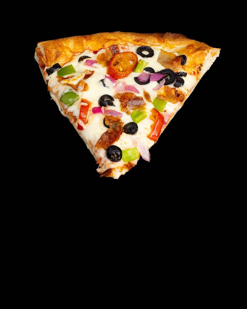 Loaded pizza slice with olives and peppers